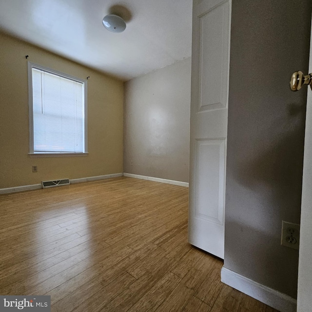 spare room featuring hardwood / wood-style flooring