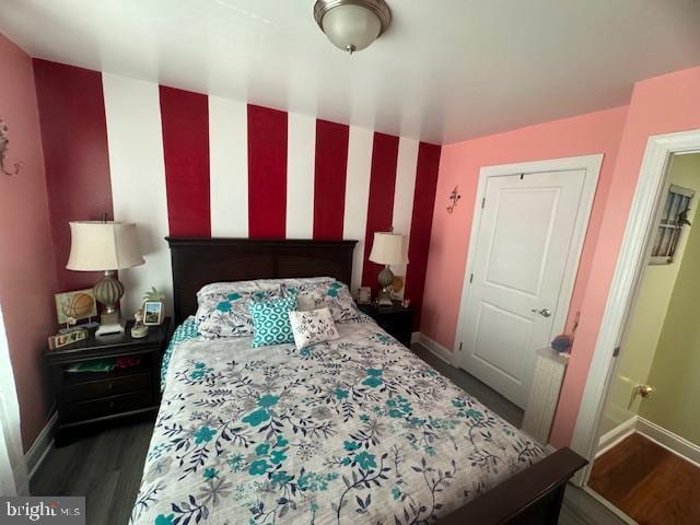 bedroom with dark wood-type flooring