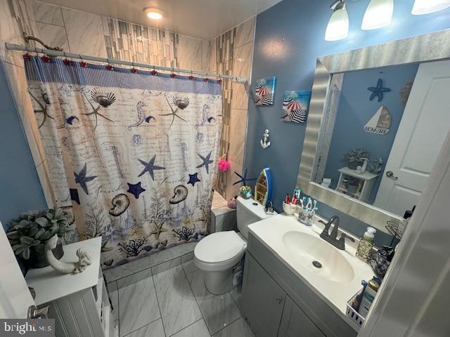 bathroom with vanity, toilet, and walk in shower