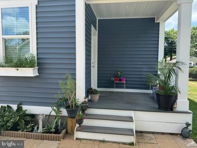 entrance to property featuring a porch