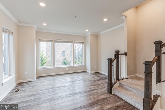 interior space featuring hardwood / wood-style flooring and crown molding