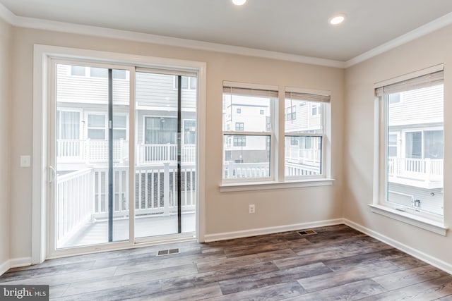 doorway featuring hardwood / wood-style flooring and crown molding