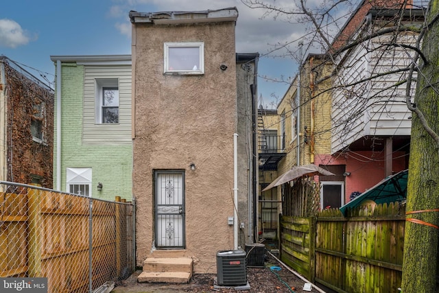 rear view of house with cooling unit