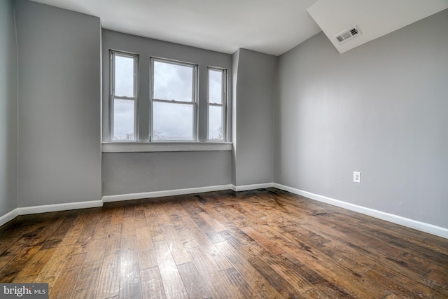 empty room with dark hardwood / wood-style floors