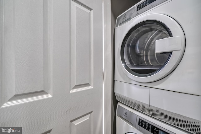 laundry area featuring stacked washer and clothes dryer