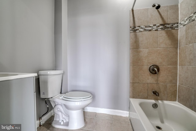 bathroom with tile patterned floors, toilet, and tiled shower / bath