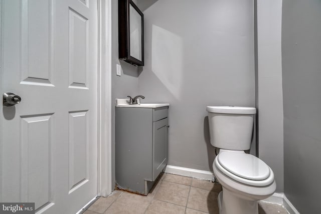 bathroom with tile patterned flooring, vanity, and toilet