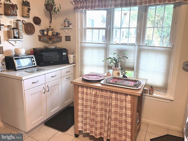 kitchen featuring white cabinetry and light tile patterned floors