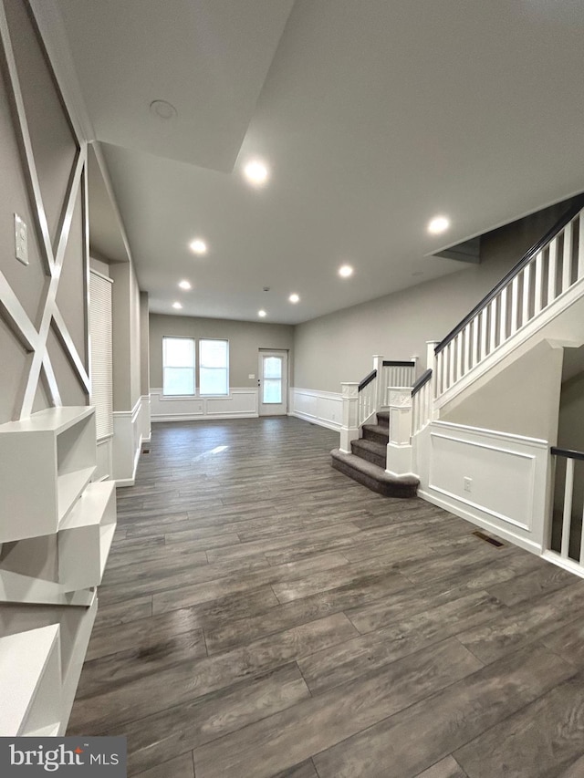 unfurnished living room featuring dark wood-type flooring