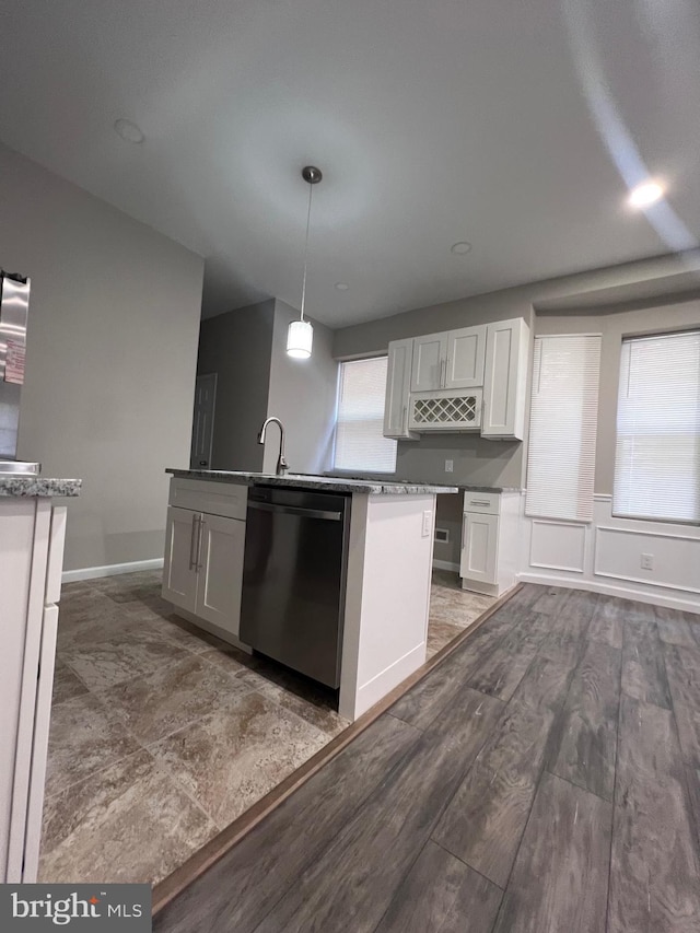 kitchen featuring white cabinets, dark hardwood / wood-style flooring, hanging light fixtures, and dishwasher