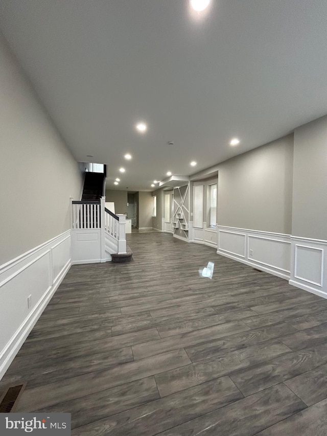 unfurnished living room with dark hardwood / wood-style flooring