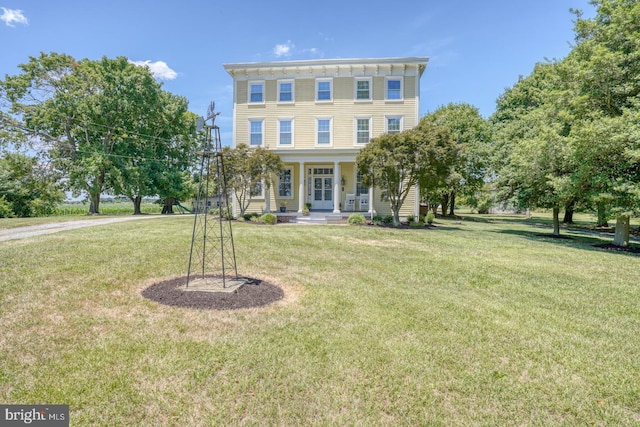 view of front of house with a front yard and a porch