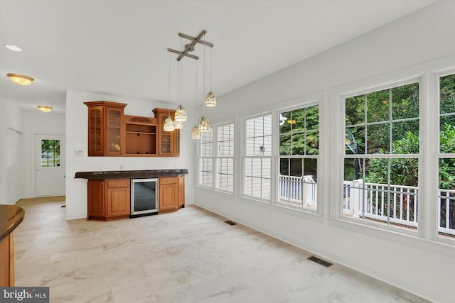 kitchen with decorative light fixtures and wine cooler