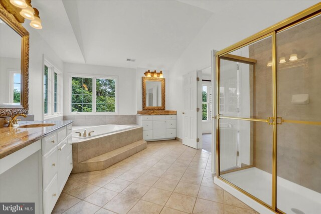 bathroom featuring vanity, tile patterned flooring, and separate shower and tub