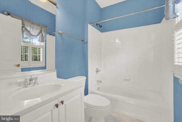 full bathroom with shower / bath combination, tile patterned flooring, vanity, and toilet