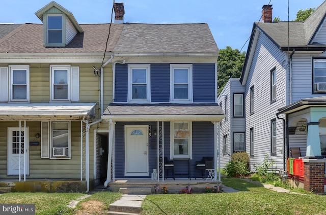 townhome / multi-family property featuring covered porch