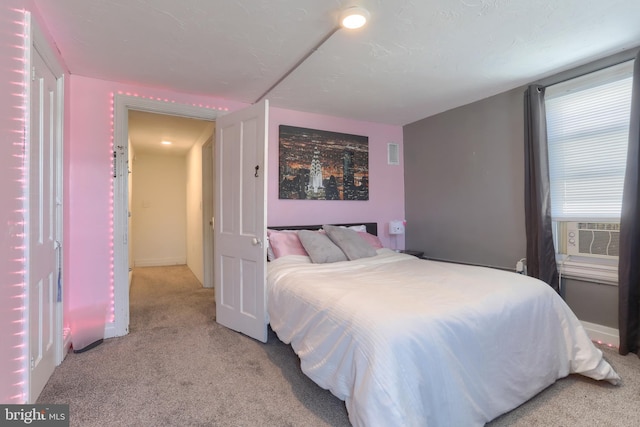 bedroom with cooling unit and light colored carpet