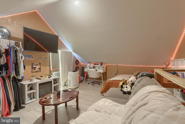 bonus room featuring vaulted ceiling and light hardwood / wood-style flooring