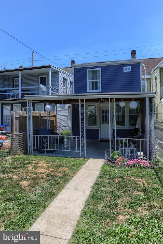 view of front of property with a porch and a front lawn