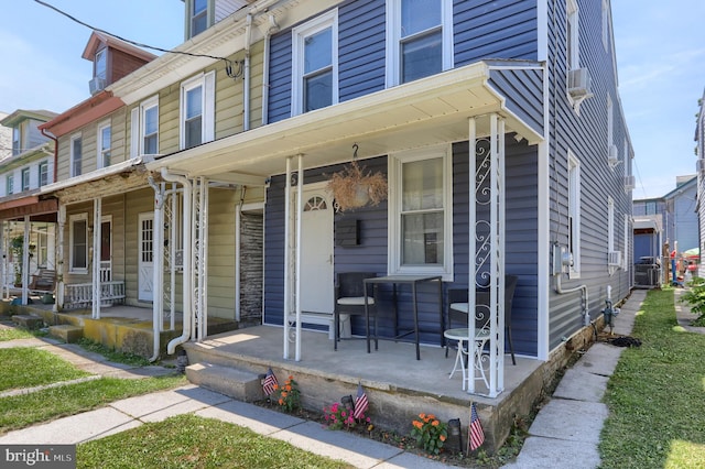 townhome / multi-family property featuring covered porch