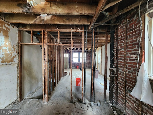 interior space featuring brick wall