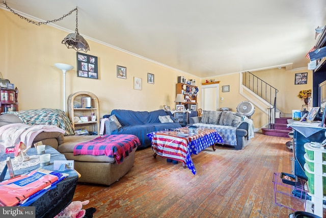 living room with hardwood / wood-style floors and crown molding