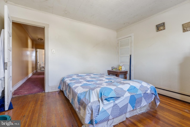 bedroom featuring ornamental molding, dark wood-type flooring, and a baseboard radiator