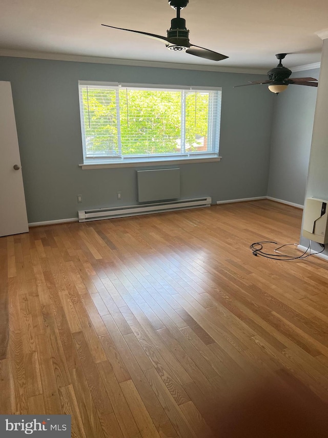 unfurnished room featuring crown molding, light hardwood / wood-style flooring, ceiling fan, and baseboard heating