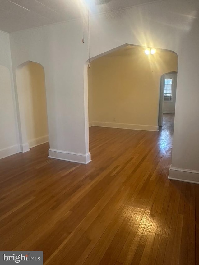 unfurnished room featuring dark hardwood / wood-style floors