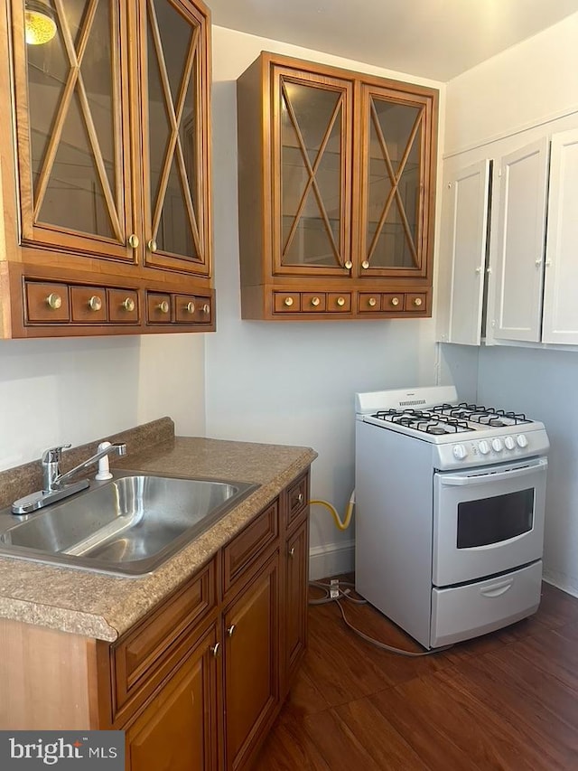 kitchen featuring white range with gas cooktop and sink