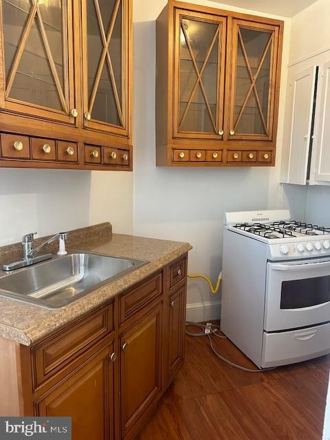 kitchen featuring white range with gas cooktop and sink