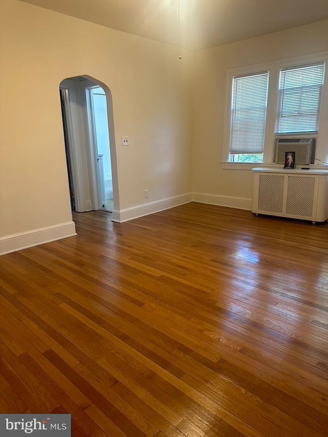 empty room with dark hardwood / wood-style flooring and cooling unit