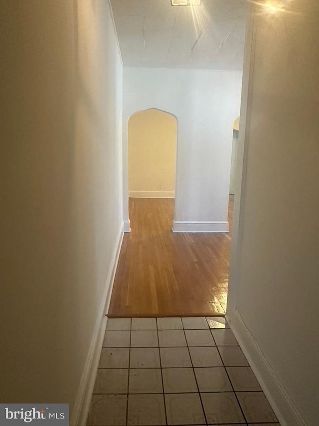 hall with light tile patterned floors