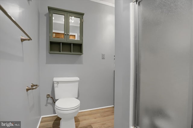 bathroom with toilet and hardwood / wood-style flooring