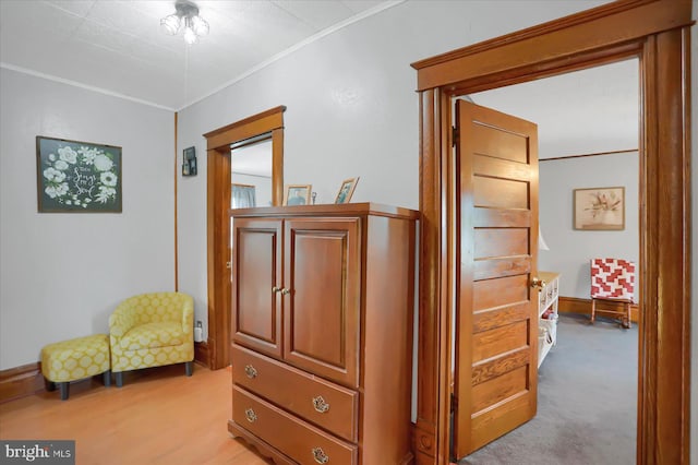 hall featuring light carpet and crown molding