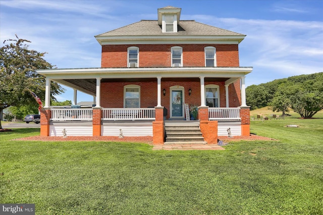 view of front of property featuring covered porch and a front lawn