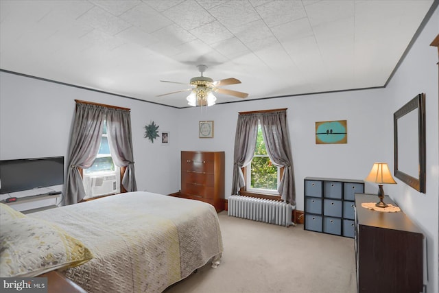 carpeted bedroom with radiator, ceiling fan, and cooling unit