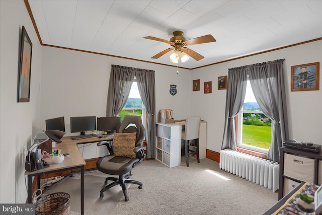 office area featuring ceiling fan, radiator heating unit, light colored carpet, and plenty of natural light