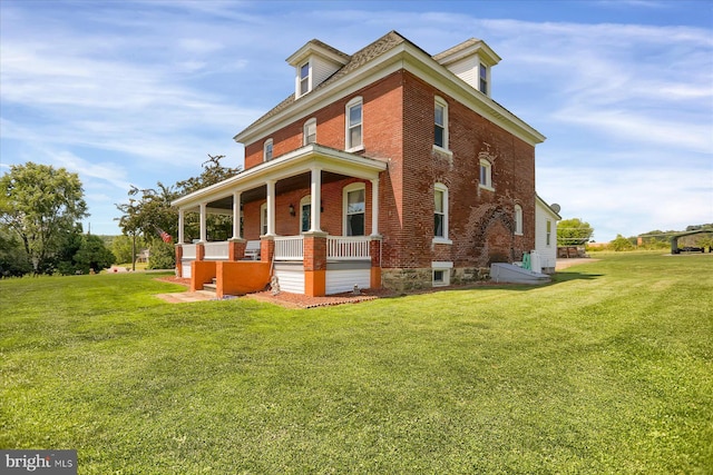 exterior space featuring a yard and covered porch