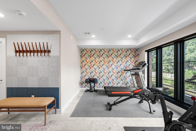 workout room with light tile patterned floors