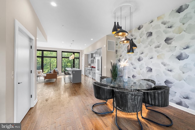 dining room featuring hardwood / wood-style flooring and sink