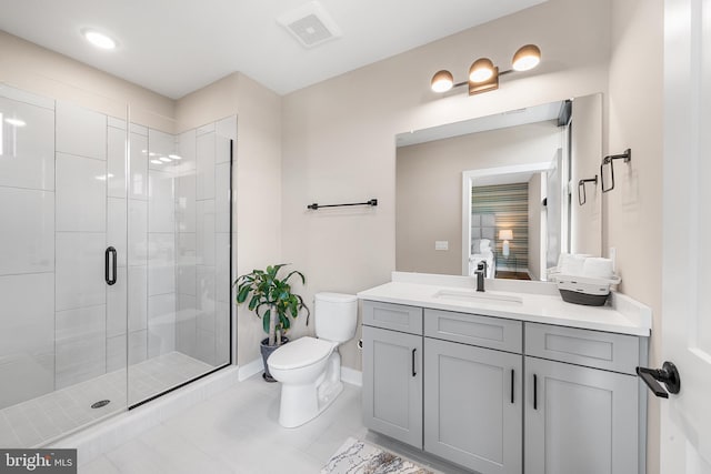 bathroom with tile patterned flooring, vanity, toilet, and a shower with door