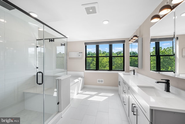 bathroom with tile patterned flooring, vanity, and plus walk in shower