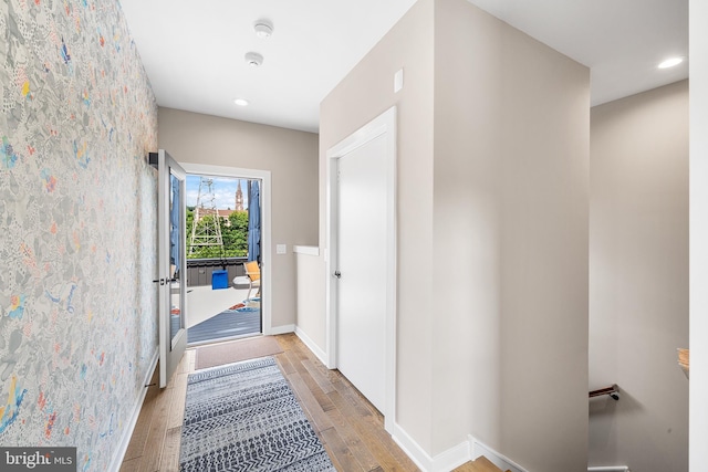 hallway with light hardwood / wood-style floors