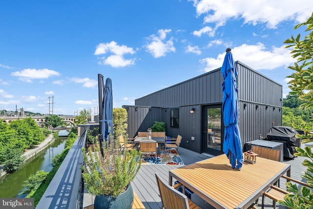 deck featuring area for grilling and a water view