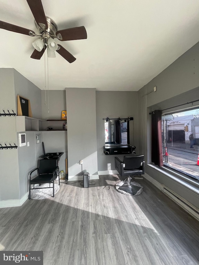 living room featuring hardwood / wood-style flooring and ceiling fan