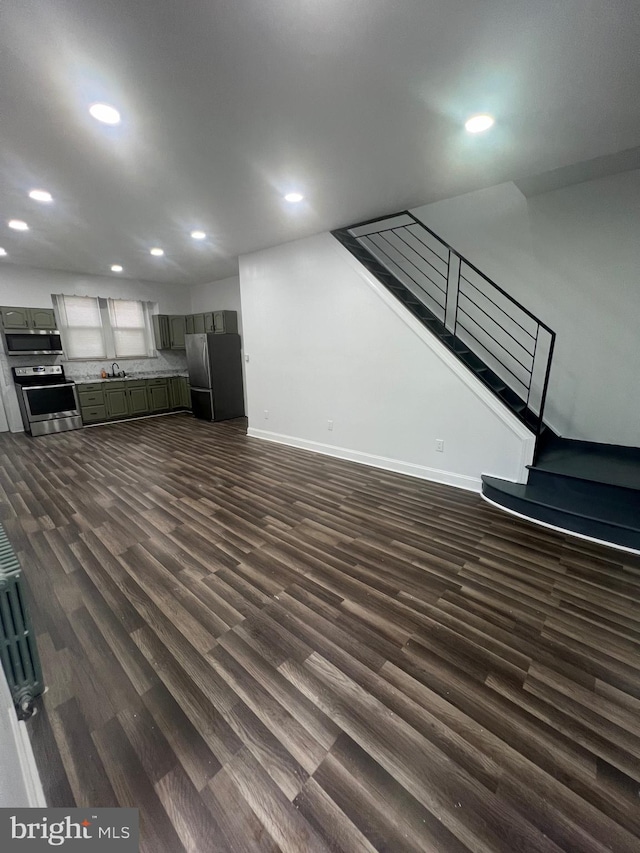 unfurnished living room with dark hardwood / wood-style floors