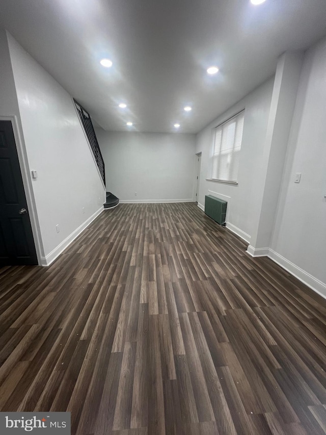 basement with dark hardwood / wood-style floors