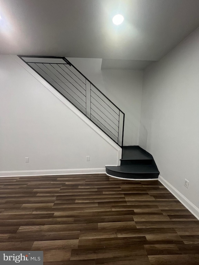 stairway featuring dark wood-type flooring