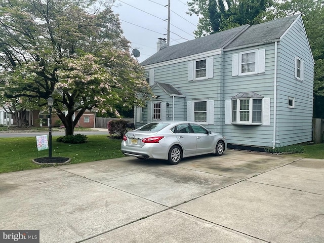 view of property exterior with a yard